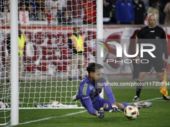 New York Red Bulls goalkeeper Carlos Coronel makes a penalty kick save to eliminate the defending MLS Cup champion Columbus Crew in Harris,...