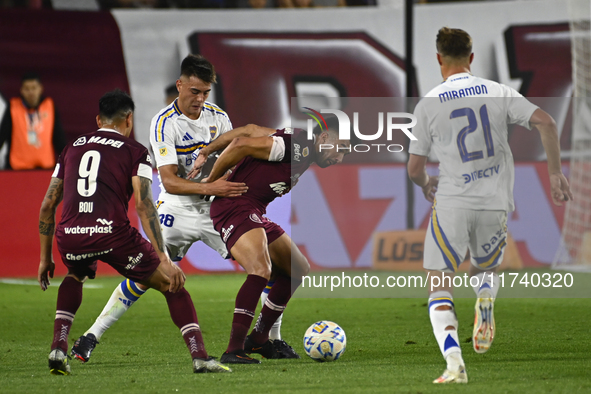 Aaron Anselmino of Boca Jrs competes for the ball against Marcelino Moreno during a Liga Profesional 2024 match between Lanus and Boca Jrs a...