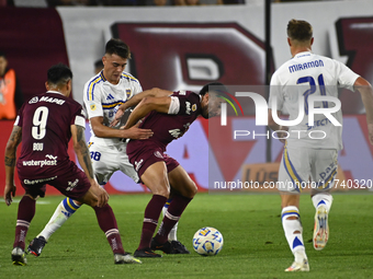 Aaron Anselmino of Boca Jrs competes for the ball against Marcelino Moreno during a Liga Profesional 2024 match between Lanus and Boca Jrs a...