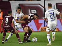 Aaron Anselmino of Boca Jrs competes for the ball against Marcelino Moreno during a Liga Profesional 2024 match between Lanus and Boca Jrs a...