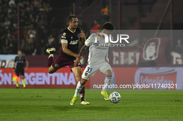 Brian Aguirre of Boca Jrs competes for the ball against Carlos Izquierdoz of Lanus during a Liga Profesional 2024 match between Lanus and Bo...