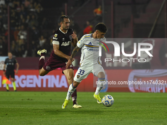 Brian Aguirre of Boca Jrs competes for the ball against Carlos Izquierdoz of Lanus during a Liga Profesional 2024 match between Lanus and Bo...