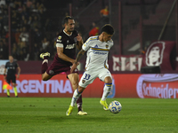 Brian Aguirre of Boca Jrs competes for the ball against Carlos Izquierdoz of Lanus during a Liga Profesional 2024 match between Lanus and Bo...