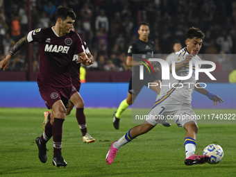 Exequiel Zeballos of Boca Jrs competes for the ball against Ezequiel Munoz of Lanus during a Liga Profesional 2024 match between Lanus and B...