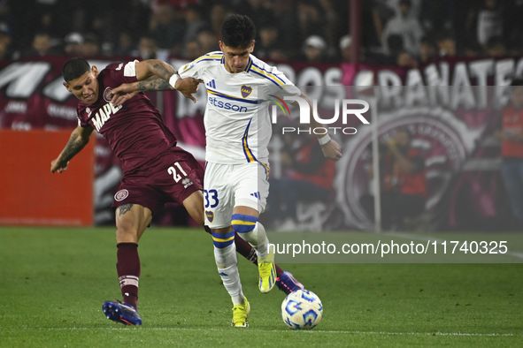 Brian Aguirre of Boca Jrs competes for the ball against Juan Jose Caseres of Lanus during a Liga Profesional 2024 match between Lanus and Bo...