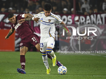 Brian Aguirre of Boca Jrs competes for the ball against Juan Jose Caseres of Lanus during a Liga Profesional 2024 match between Lanus and Bo...