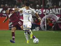 Brian Aguirre of Boca Jrs competes for the ball against Juan Jose Caseres of Lanus during a Liga Profesional 2024 match between Lanus and Bo...