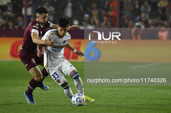 Brian Aguirre of Boca Jrs competes for the ball against Felipe Pena Biafore of Lanus during a Liga Profesional 2024 match between Lanus and...