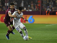 Brian Aguirre of Boca Jrs competes for the ball against Felipe Pena Biafore of Lanus during a Liga Profesional 2024 match between Lanus and...