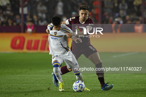 Brian Aguirre of Boca Jrs competes for the ball against Felipe Pena Biafore of Lanus during a Liga Profesional 2024 match between Lanus and...