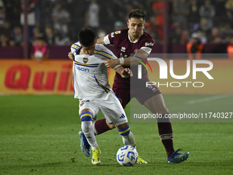 Brian Aguirre of Boca Jrs competes for the ball against Felipe Pena Biafore of Lanus during a Liga Profesional 2024 match between Lanus and...