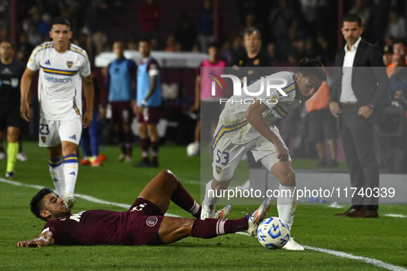 Joquin Ruiz of Boca Jrs competes for the ball against Eduardo Salvio of Lanus during a Liga Profesional 2024 match between Lanus and Boca Jr...