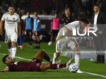 Joquin Ruiz of Boca Jrs competes for the ball against Eduardo Salvio of Lanus during a Liga Profesional 2024 match between Lanus and Boca Jr...