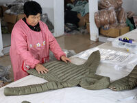 Workers make down jackets at a workshop of a garment manufacturer in Hehe town, Yangxin county, Binzhou city, East China's Shandong province...