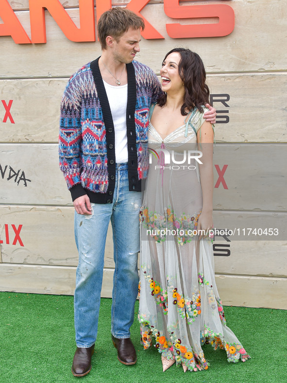 Drew Starkey and Fiona Palomo arrive at Netflix's Poguelandia 2024 Event Celebrating 'Outer Banks' Season 4 Part 2 held at Barker Hangar on...