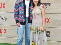 Drew Starkey and Fiona Palomo arrive at Netflix's Poguelandia 2024 Event Celebrating 'Outer Banks' Season 4 Part 2 held at Barker Hangar on...