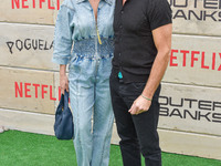 Brianna Brown and Tony Crane arrive at Netflix's Poguelandia 2024 Event Celebrating 'Outer Banks' Season 4 Part 2 held at Barker Hangar on N...