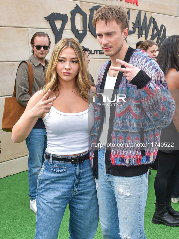 Madelyn Cline and Drew Starkey arrive at Netflix's Poguelandia 2024 Event Celebrating 'Outer Banks' Season 4 Part 2 held at Barker Hangar on...