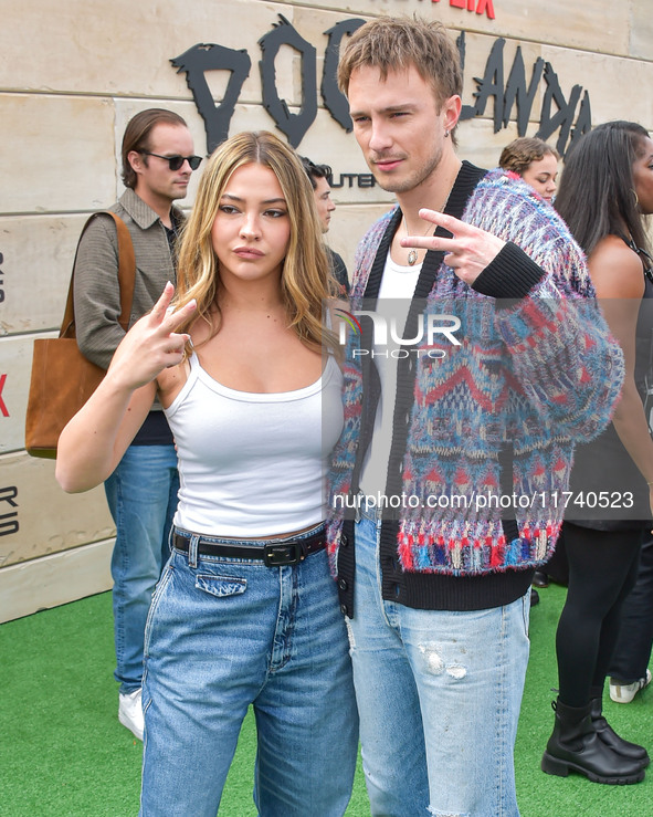 Madelyn Cline and Drew Starkey arrive at Netflix's Poguelandia 2024 Event Celebrating 'Outer Banks' Season 4 Part 2 held at Barker Hangar on...