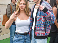 Madelyn Cline and Drew Starkey arrive at Netflix's Poguelandia 2024 Event Celebrating 'Outer Banks' Season 4 Part 2 held at Barker Hangar on...