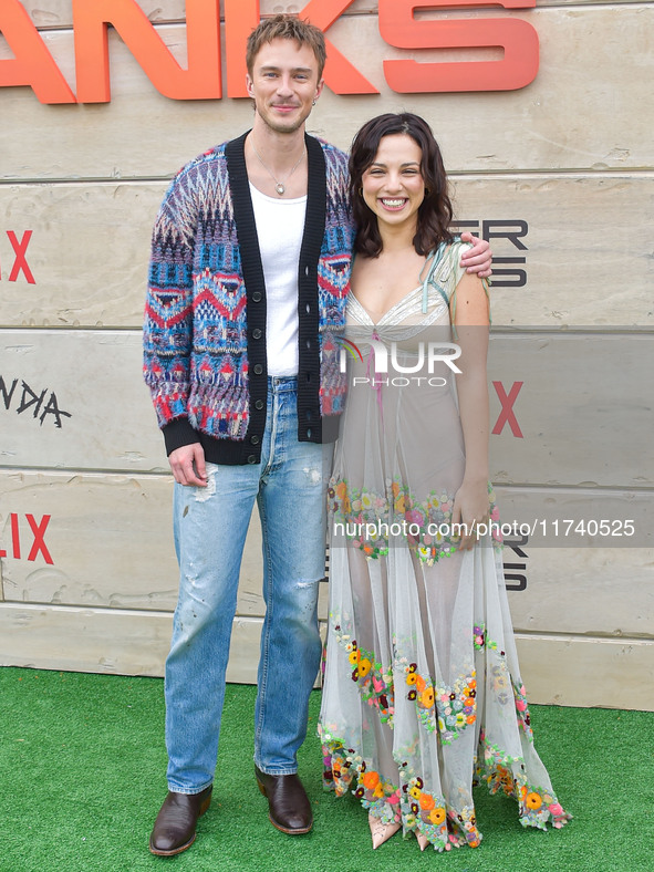 Drew Starkey and Fiona Palomo arrive at Netflix's Poguelandia 2024 Event Celebrating 'Outer Banks' Season 4 Part 2 held at Barker Hangar on...