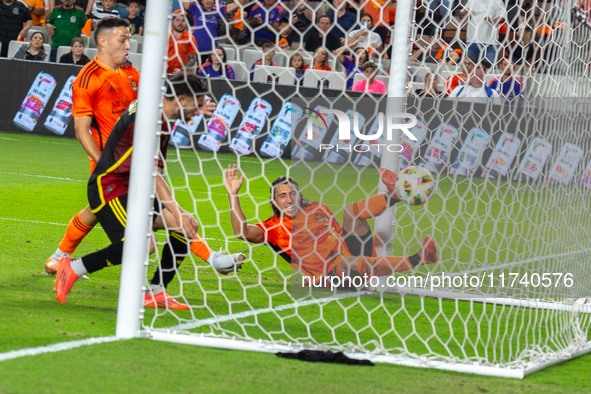 Houston Dynamo player Griffin Dorsey slides into Seattle's net after deflecting the ball off Seattle Sounders defender Alex Roldan for an ow...