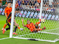 Houston Dynamo player Griffin Dorsey slides into Seattle's net after deflecting the ball off Seattle Sounders defender Alex Roldan for an ow...