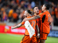 Houston Dynamo players celebrate after a goal during a playoff match in Houston, Texas, on November 3, 2024, at Shell Energy Stadium. (