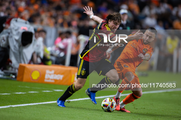 Seattle Sounders forward Pedro de la Vega battles for the ball with Houston Dynamo midfielder Sebastian Kowalczyk during a playoff match bet...