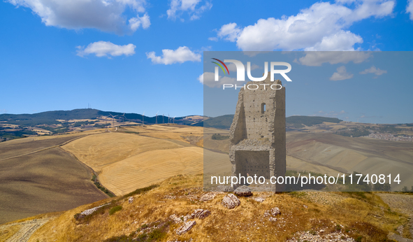 A unique view of the ruins of a Norman tower, shaped like a giant chair, perches atop a hill in Pietramontecorvino, Foggia, Italy, on August...