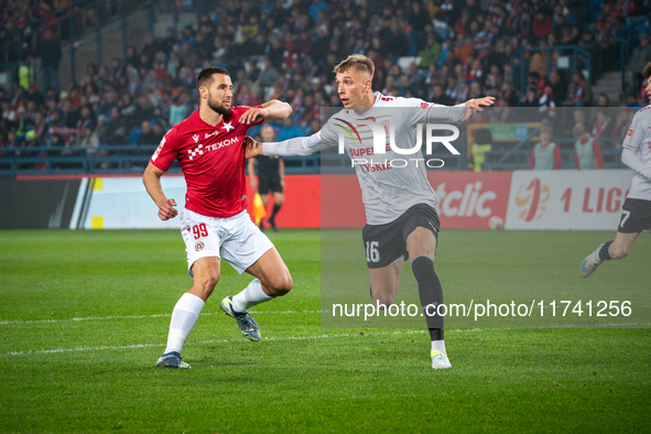 Lukasz Zwolinski and Jakub Budnicki participate in the game between Wisla Krakow and GKS Tychy in Krakow, Poland, on November 4, 2024. This...