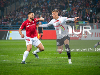 Lukasz Zwolinski and Jakub Budnicki participate in the game between Wisla Krakow and GKS Tychy in Krakow, Poland, on November 4, 2024. This...