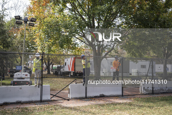 Crews outside the White House in Washington, DC, on November 4, 2024, reinforce the fence as a safety precaution. 