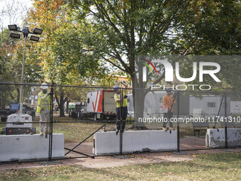 Crews outside the White House in Washington, DC, on November 4, 2024, reinforce the fence as a safety precaution. (