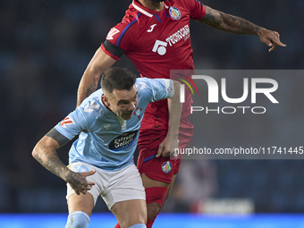 Omar Alderete of Getafe CF competes for the ball with Iago Aspas of RC Celta de Vigo during the La Liga EA Sports match between RC Celta de...