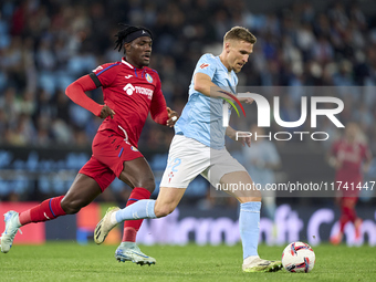 Carl Starfelt of RC Celta de Vigo is challenged by Christantus Uche of Getafe CF during the La Liga EA Sports match between RC Celta de Vigo...