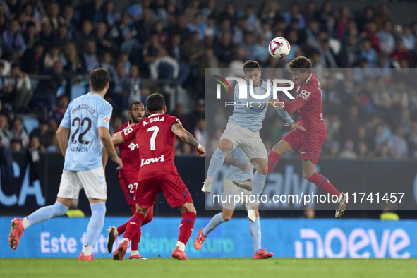 Fran Beltran of RC Celta de Vigo competes for the ball with Luis Milla of Getafe CF during the La Liga EA Sports match between RC Celta de V...