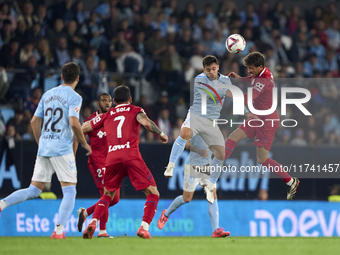 Fran Beltran of RC Celta de Vigo competes for the ball with Luis Milla of Getafe CF during the La Liga EA Sports match between RC Celta de V...