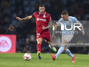 Iago Aspas of RC Celta de Vigo is challenged by Diego Rico of Getafe CF during the La Liga EA Sports match between RC Celta de Vigo and Geta...