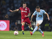 Iago Aspas of RC Celta de Vigo is challenged by Diego Rico of Getafe CF during the La Liga EA Sports match between RC Celta de Vigo and Geta...