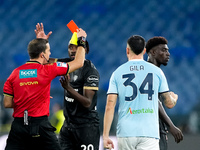 Referee Nicola Ayroldi shows a red card to Michel Ndary Adopo of Cagliari Calcio during the Serie A Enilive match between SS Lazio and Cagli...