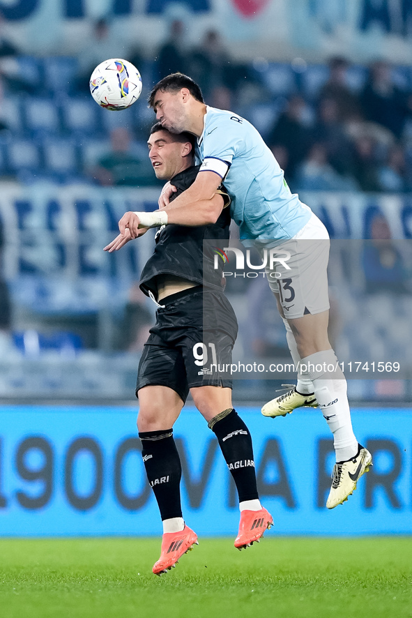 Roberto Piccoli of Cagliari Calcio and Alessio Romagnoli of SS Lazio jump for the ball during the Serie A Enilive match between SS Lazio and...