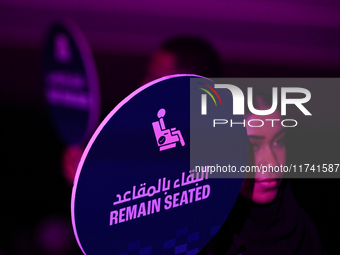 RIYADH, SAUDI ARABIA - NOVEMBER 04: A staff member holds a 'Remain Seated' sign as fans arrive ahead of Elena Rybakina of Kazakhstan's match...