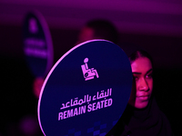 RIYADH, SAUDI ARABIA - NOVEMBER 04: A staff member holds a 'Remain Seated' sign as fans arrive ahead of Elena Rybakina of Kazakhstan's match...