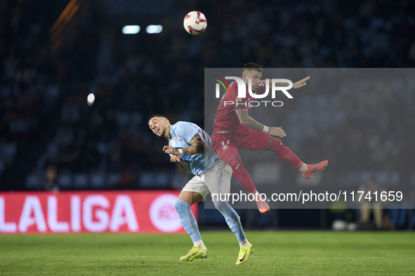 Carles Perez of Getafe CF competes for the ball with Mihailo Ristic of RC Celta de Vigo during the La Liga EA Sports match between RC Celta...