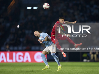 Carles Perez of Getafe CF competes for the ball with Mihailo Ristic of RC Celta de Vigo during the La Liga EA Sports match between RC Celta...