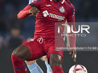 Christantus Uche of Getafe CF is challenged by Carl Starfelt of RC Celta de Vigo during the La Liga EA Sports match between RC Celta de Vigo...