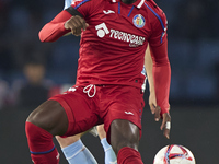 Christantus Uche of Getafe CF is challenged by Carl Starfelt of RC Celta de Vigo during the La Liga EA Sports match between RC Celta de Vigo...