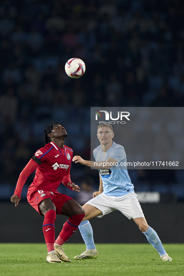 Carl Starfelt of RC Celta de Vigo competes for the ball with Christantus Uche of Getafe CF during the La Liga EA Sports match between RC Cel...