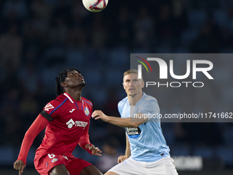 Carl Starfelt of RC Celta de Vigo competes for the ball with Christantus Uche of Getafe CF during the La Liga EA Sports match between RC Cel...